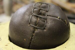 Image of a leather ball, newly stitched together